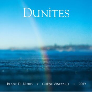 Dunites Chêne Vineyards Blanc de Noirs 2019 label; white text on a background of deep blue sea set against blue sky