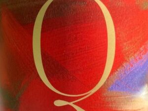 Old Vine 1901 Mixed Field Blend 2019; A square label with an abstract background mostly in shades of red, with a dash of purple and gold, with a large golden capital Q