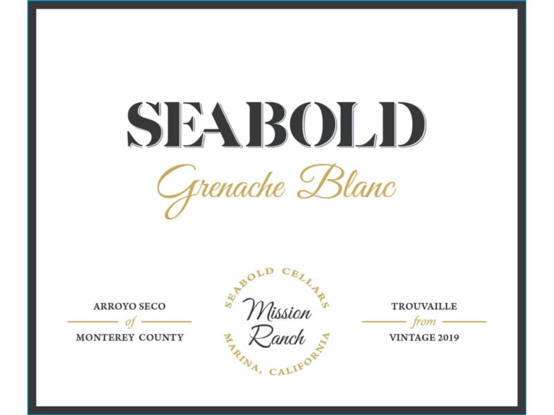Seabold Grenache Blanc 2019; A black bordered white rectangular label. Black and gold text towards the top. Two lines of black text towards the bottom, divided horizontally by a gold separator. The text is separated further by a circle of gold text in the middle, with more grey text inside the circle.