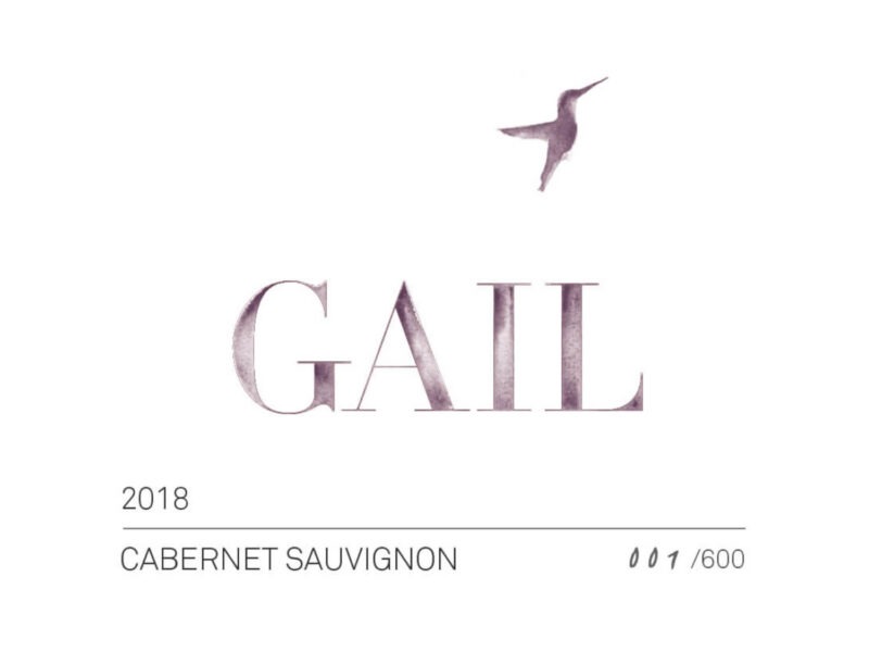 GAIL Deering Cabernet Sauvignon 2018 label GAIL Pickberry Merlot 2018 label: A simple white rectangular label showing a humming bird in silhouette hovering above dark text